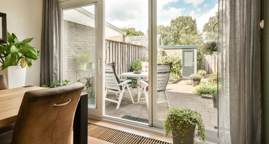 Sliding glass door connecting home to a paver patio